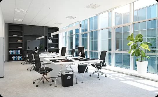 Modern office interior with workstations, glass walls, and natural light